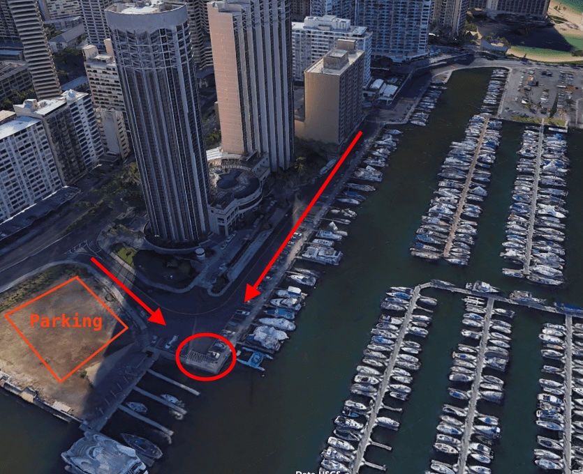 Aerial view of marina with numerous boats and labeled parking area.